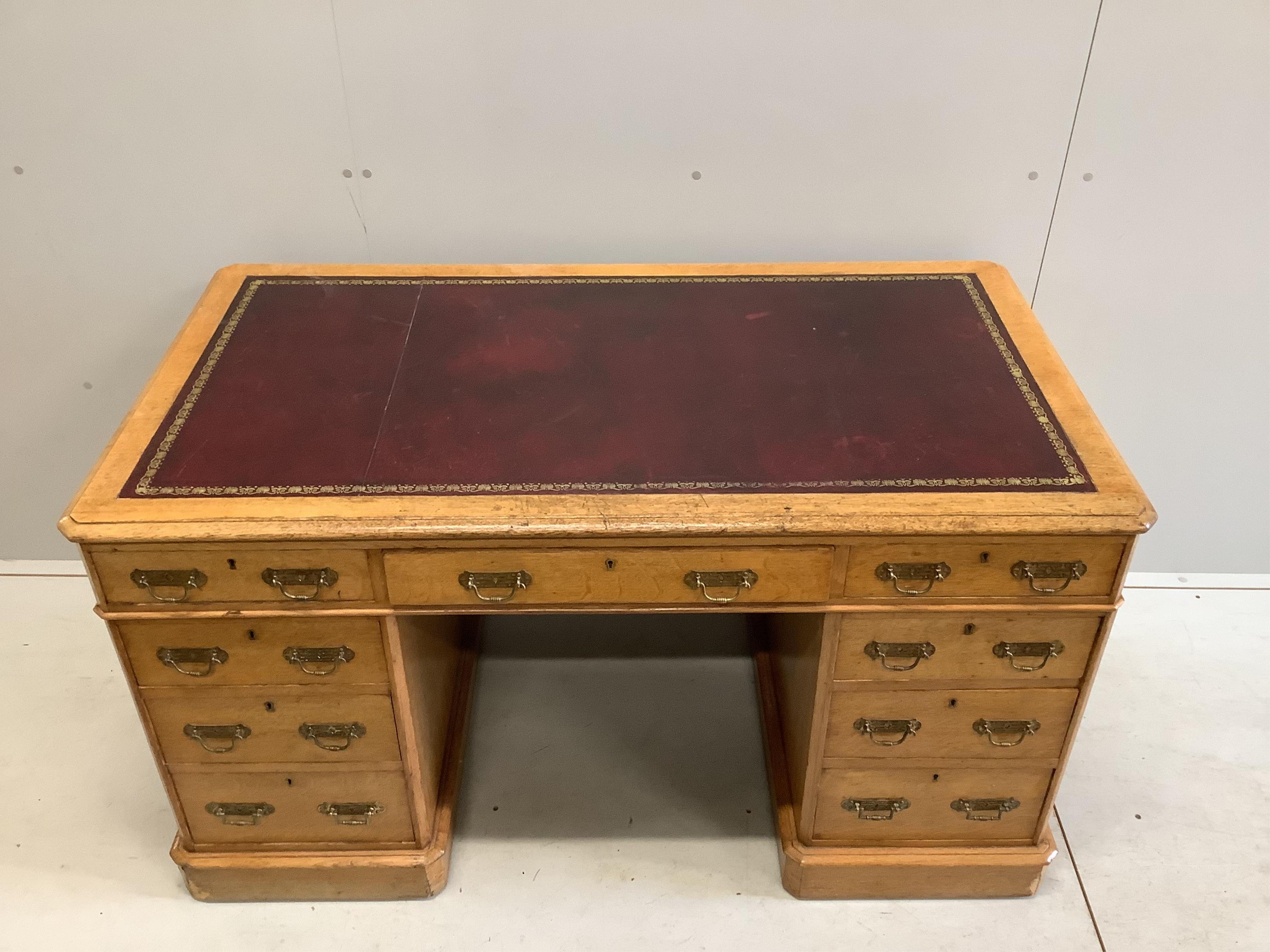 A Victorian golden oak pedestal desk, stamped E Buckham, width 136cm, depth 74cm, height 76cm. Condition - fair to good